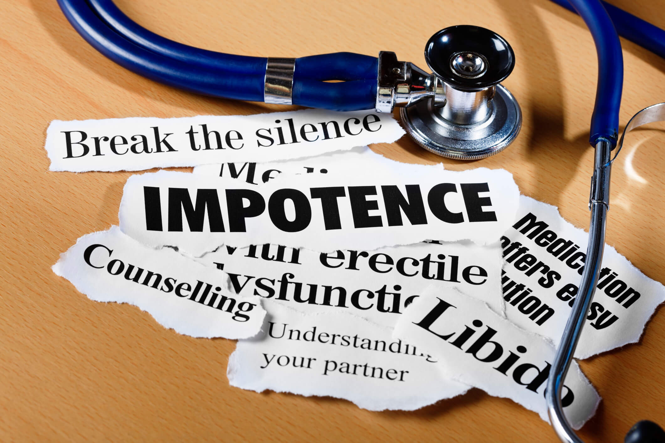 A stethoscope rests on a stack of papers labeled "Impotence", symbolizing the connection between medical examination and Erectile Dysfunction.